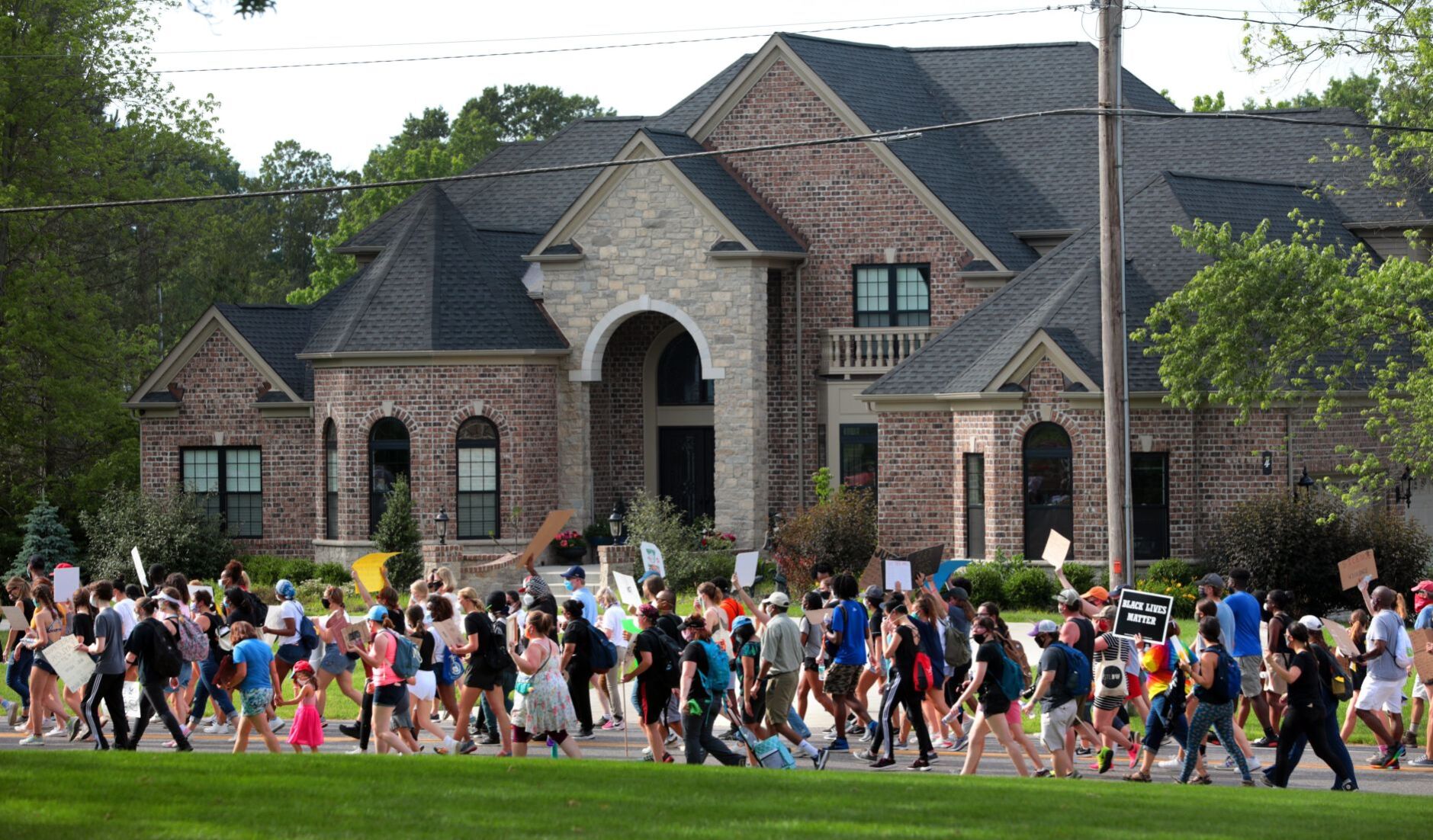 Youth march moves through wealthy suburbs